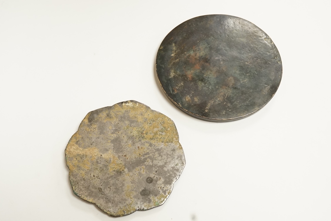 Two Chinese metal hand-mirrors, largest 13cm